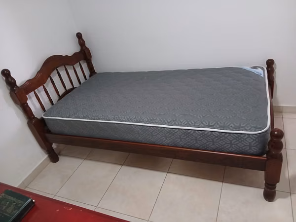 Wooden bed with mattress