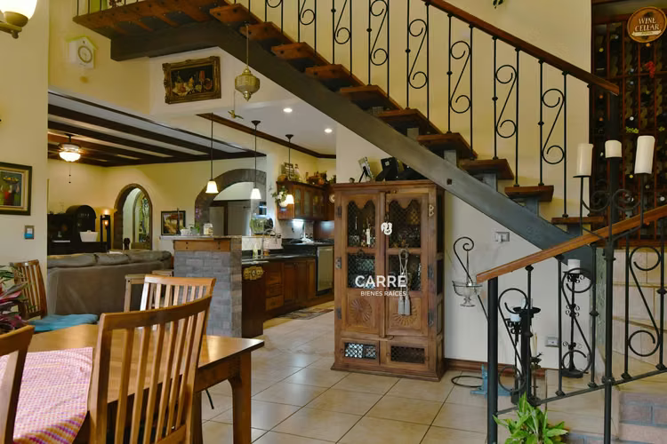 Casa de un nivel rodeada de jardines, en condominio.